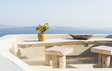 brown pot with green plant on wooden bench